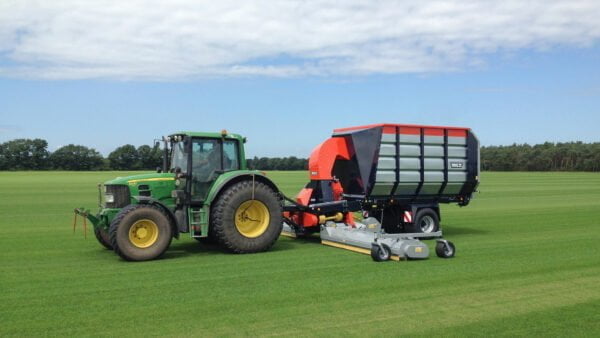 Vacuum trailer wide-area sweeping and collecting on a sod farm