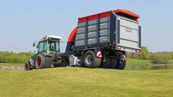 Vacuum trailer sweeping and collecting on golf course